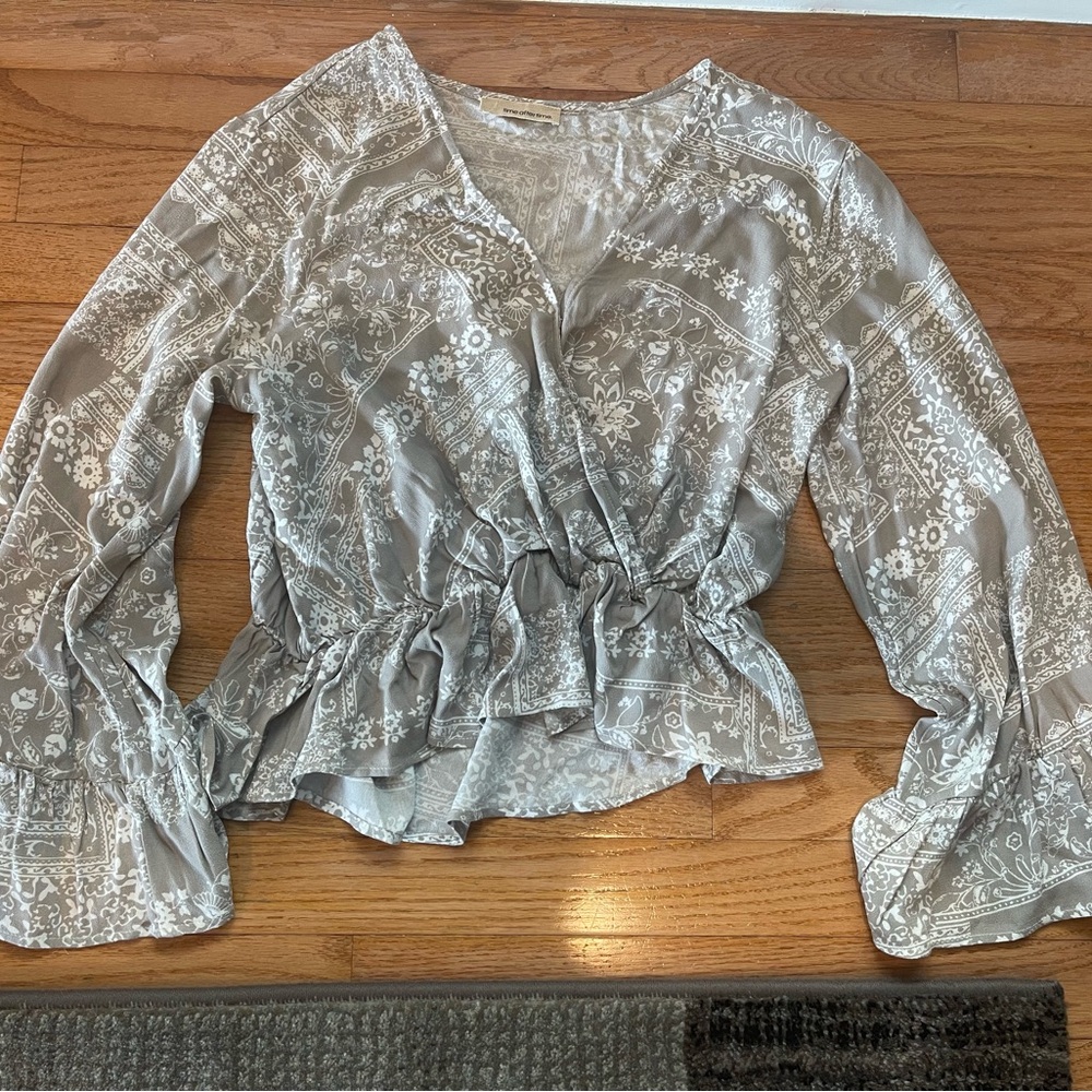 Grey and white flutter sleeve with snap closing in front in size small top